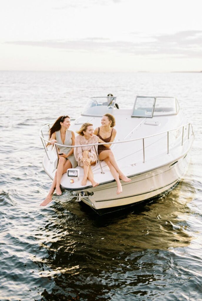 Three friends enjoying a sunny day relaxing on a boat at sea.